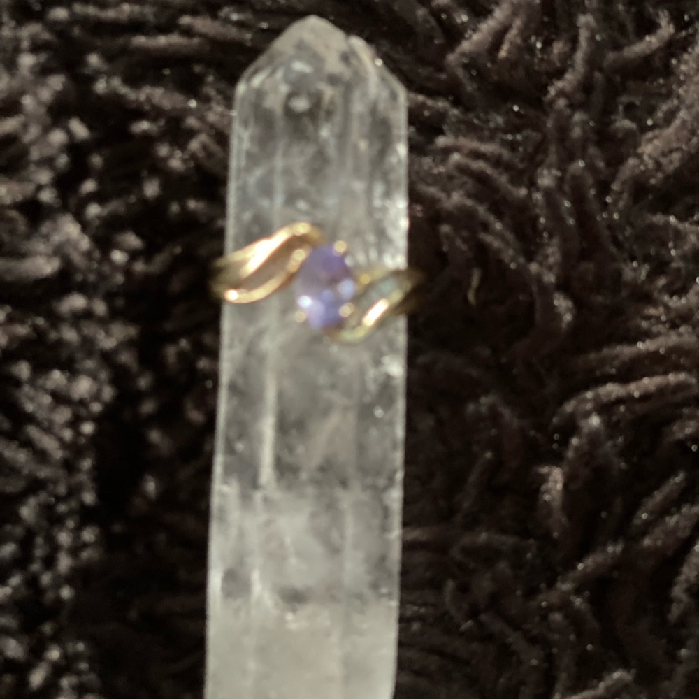 10k yellow gold with center oval tanzanite with baguette accents side diamonds.